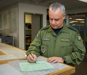Last name in the log book - Lieutenant-Colonel Philip Marcus signs his name as the last entry in CC130307’s log book before its retirement at 424 (Transport and Rescue) Squadron at 8 Wing/Canadian Forces Base Trenton on April 5, 2016. Photo: Master Corporal St. Amour, 8 Wing Imaging
