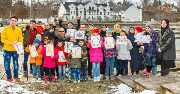 This photograph, posted to the PEC Syria Facebook earlier this spring, showing the families offering thanks, was taken by Daniel Vaughan.