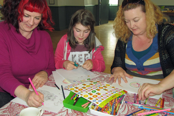 Susanne Larner, Maeve Sanderson and Shelby Larner creating drawings and writing letters of support for the children of Attawapiskat