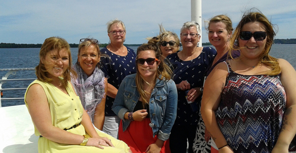 The foundation's cruise committee members take a moment to pose for a photo onboard the ship. Susan deWolfe photos