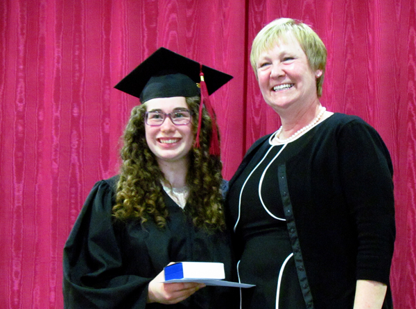Sara Evans received the Governor General's Academic Medal from Mandy Savery Whiteway, Board Director.