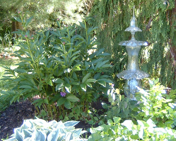 This photo by Lynn Weber shows Victorian garden totem, she bought at last year's tea. This year, glass artist Janet Wager has donated similar totems with solar lights for the auction, and a number of unique teapot totems.