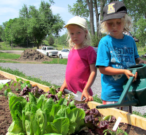 Violet and Noah Blower tend to the gardening on planting day at the Community Gardens at Delhi Park.