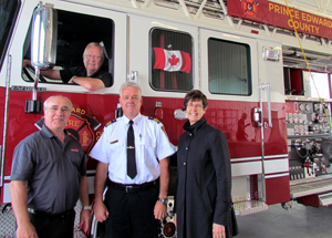 Mayor Robert Quaiff beams after driving the fire truck. Fire Chief Scott Manlow and Darch Fire Service Manager Manny Costa, explained the advantages and benefits of the truck to the mayor and commissioner of corporate services and finance, Susan Turnbull.