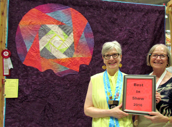 Show co-chairs Maggie Goode and Janet Reader Day with her Best in Show quilt.