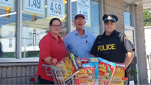 Addie Pierson and Cline Pierson, of Foodland in Wellington, with PEC Community Safety Officer Connor Durkin to launch the Push for Change initiative.
