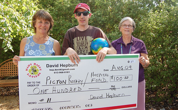 David Hepburn, on behalf of his Many Happy Returns initiative, presents $100 to Marion Hughes (right), president of the Rotary Club of Picton and Monica Alyea, chair of the PECMH Foundation. The funds were collected through bottle returns from the Wine Passport to Canada tasting event hosted by Picton Rotary and the PECM Hospital Foundation in July at the Crystal Palace. David MacKay photo