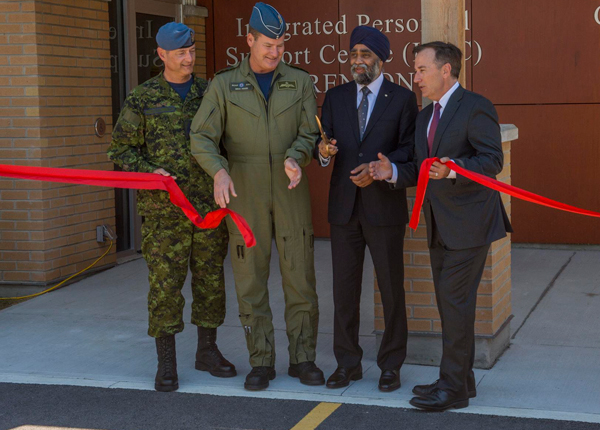 The Minister of National Defence Harjit Sajjan officially opens the Integrated Personnel Support Centre at 8 Wing/CFB Trenton with a ribbon cutting. From left, Royal Canadian Air Force Chief Warrant Officer Gérard Poitras, RCAF Commander Lieutenant-General Michael Hood, Minister of National Defence Harjit Sajjan, Member of Parliament Bay of Quinte Neil Ellis.
