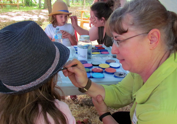 New to the County, Amelia and Natalie (and brother Benjamin, not shown) had their faces painted before touring the fun at the Sugar Shack.