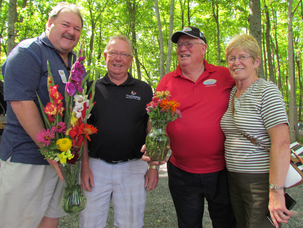 Gary Silcok, who purchased PEC Mayor Robert Quaiff's arrangement, shown with Quinte West Mayor Jim Harrison, holding the poseys purchased by a supportive wife, Jane.