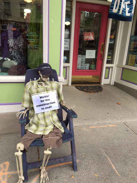 Lesley Snider, of Rosehaven Yarn Shop, says Mr. Bo Jangles, who is sitting outside of her shop, can't wait for the construction to finish!