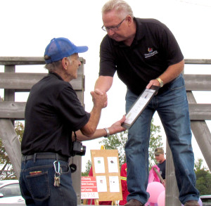 Long-time fair volunteer Bruce Dowdell receives a certificate from the County honouring the fair's 70th anniversary.