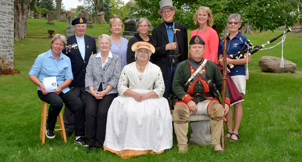 Veterans' Day sponsors, participants and organizers came together at Glenwood for a pre-event photo. From left, front row: Sandra Latchford, Chair Glenwood Cemetery Board; Wendy Daxon and Leigh Moore, Loyalist Portrayal. Back row: Helma Oonk, Manager Glenwood Cemetery; Rev. Bill Kidnew, Chaplain Branch 78 Royal Canadian Legion; Barb Proctor, Director Community Service Rotary Club of Picton; Marion Hughes, President Rotary Club of Picton; Don Roberts, your huide; Lana Whitteker, McDougall Insurance and Susan March, civilian volunteer with 8 Wing Pipes & Drums. - Peggy deWitt photo