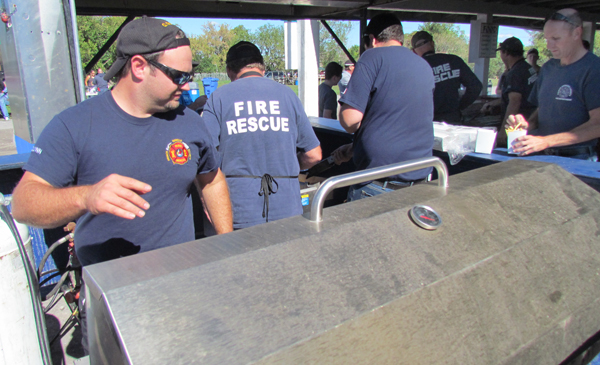Volunteer firefighters kept up to the demand for their delicious hamburgers and fries.