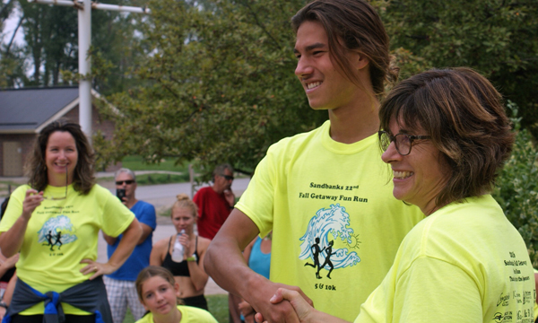 Nate St. Romain, 17, who was first over the line for the 5km event, with Agnese Bortolussi, race director. Theresa Durning photo