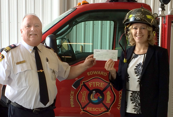 PEC Deputy Fire Chief Robert Rutter receives the $7,500 Enbridge Safe Community Program grant from Suzanne Shea, Community Engagement Advisor.