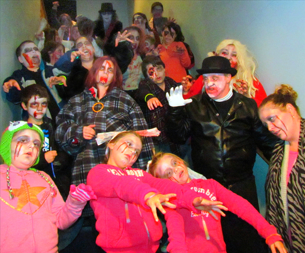 2016's Zombie Walkers fill the old Town Hall stairway on their way outside to shamble downtown Picton.