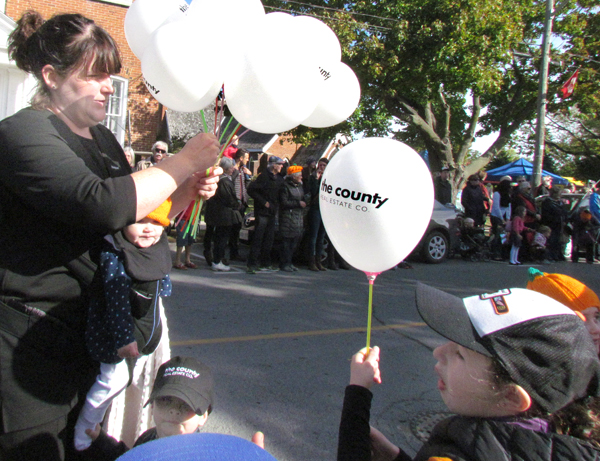Children along the route enjoyed receiving candies and this year, balloons, from the new County Real Estate Co.