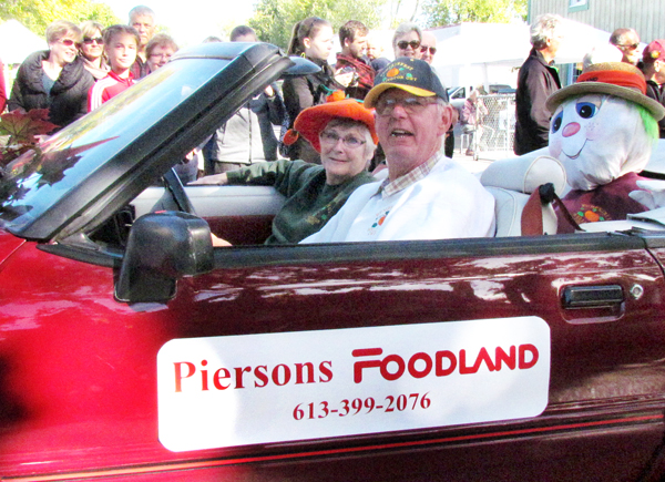 The Piersons among a number of motorists driving beautiful cars down the parade route.