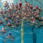 A waterfall of ribbons and medals for swim team members