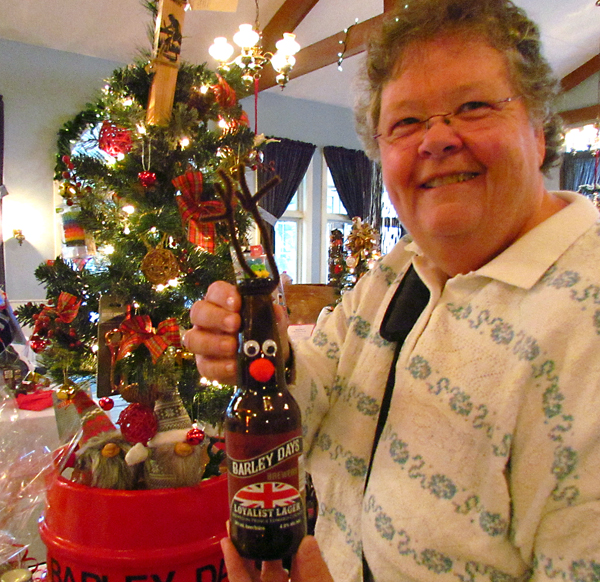 Barb Hogan with "reindeer brew" from the Barley Days Brewery donation.