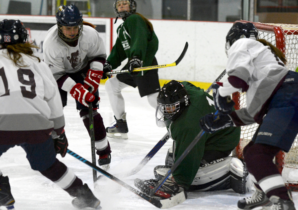 Tynika Williams, Sydney Davies and Kendra Marion look to get the puck.