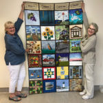 Quilters stitch up window on the County for display at the hospital