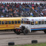 School buses skirt weather to thrill packed crowd at Speedway