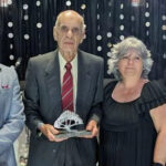 Bruce Dowdell takes the stage as VIQ Volunteer of the Year