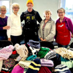 Hospital auxiliary knitters help keep kids warm one stitch at a time